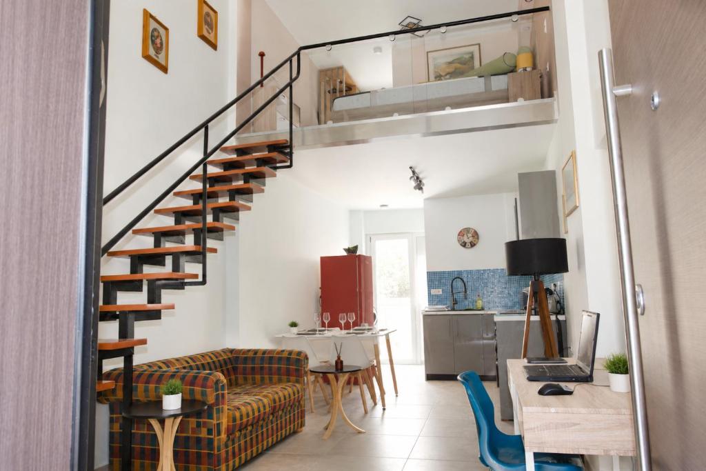 Inside the Athens Mets Loft: the sculptural staircase rising to the mezzanine above the open living and dining space